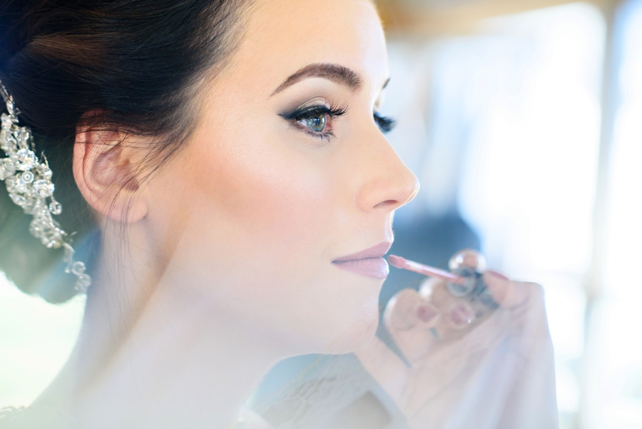 Lipstick gets applied to the bride's lips moments before the ceremony.